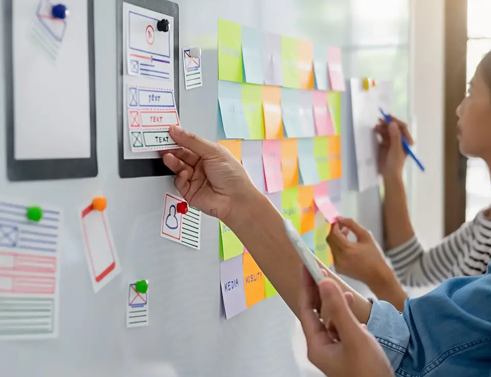a group of people holding sticky notes