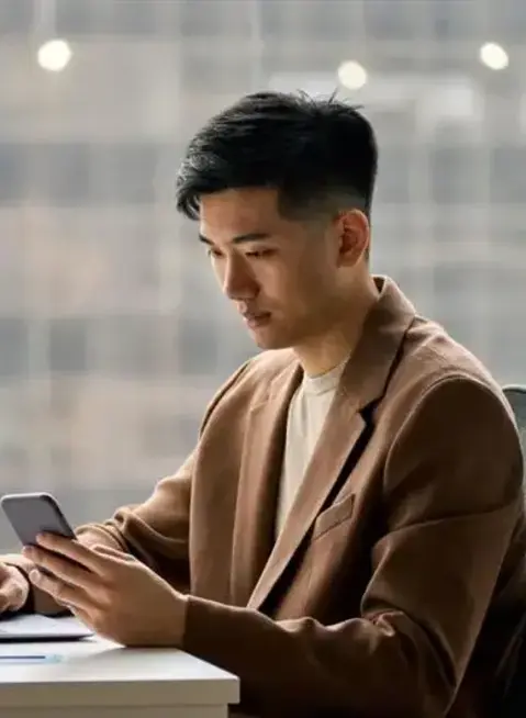 a man sitting at a desk using a laptop