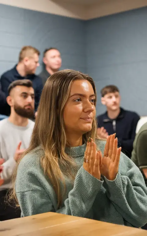 a group of people clapping