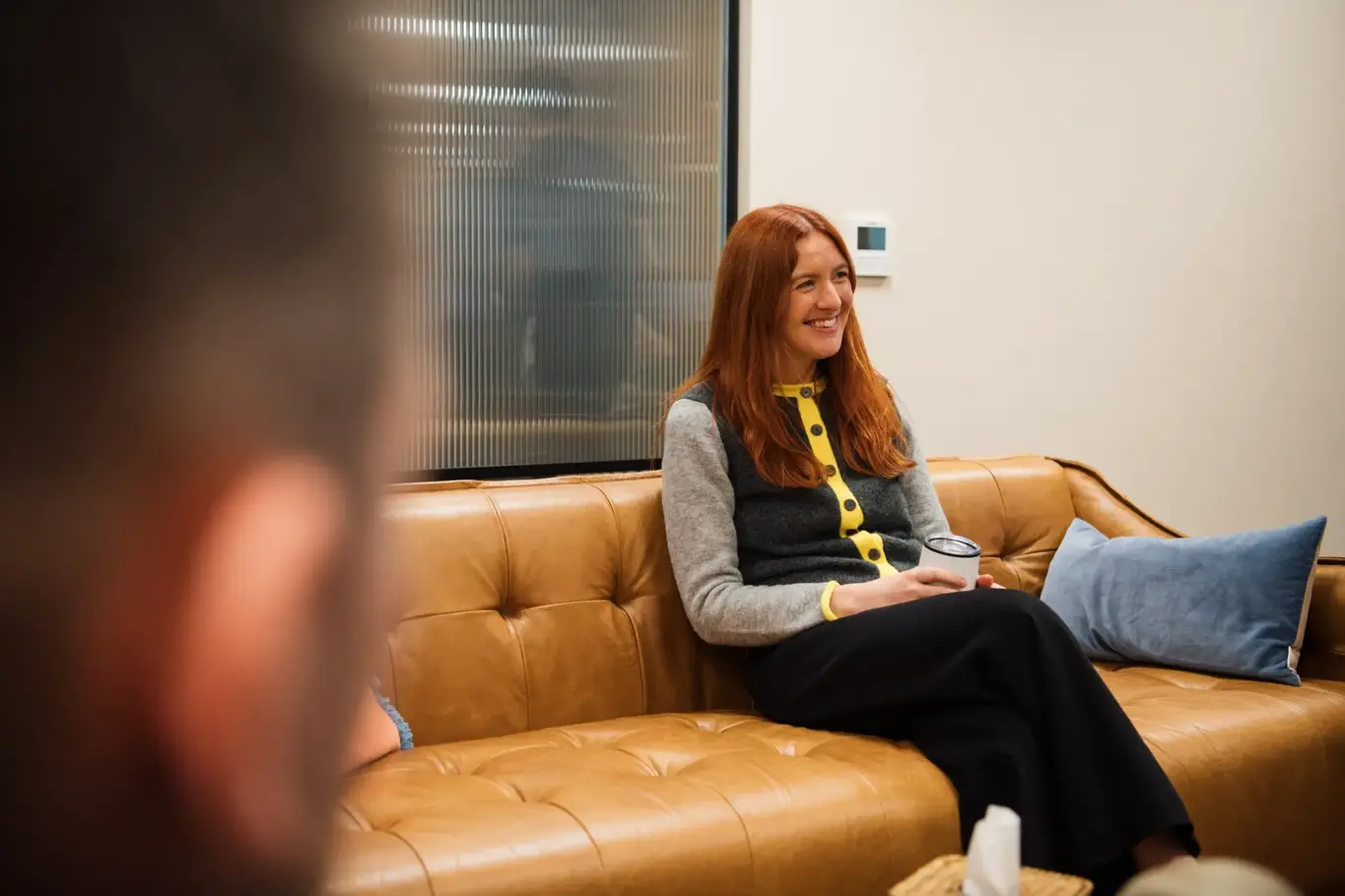a woman sitting on a couch