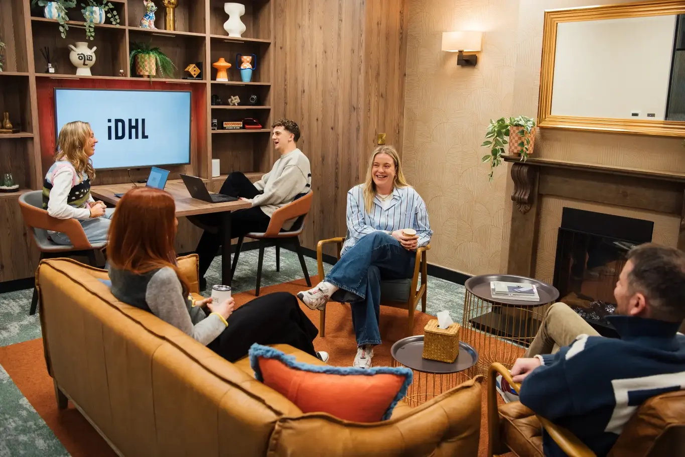 Group of IDHL employees talking and smiling