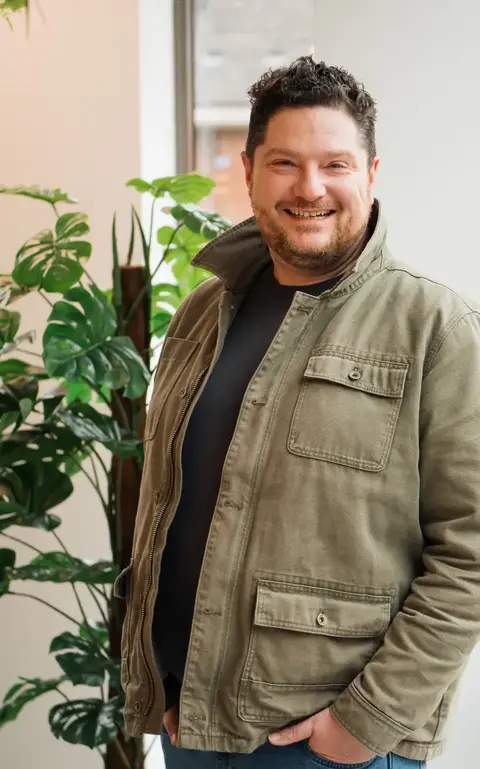 a man standing in front of a window